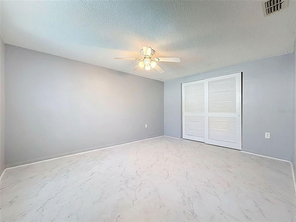 9610 Rainbow Lane Port Richey, FL 34668 - Photo 26 of 34 an empty room with a ceiling fan and a window