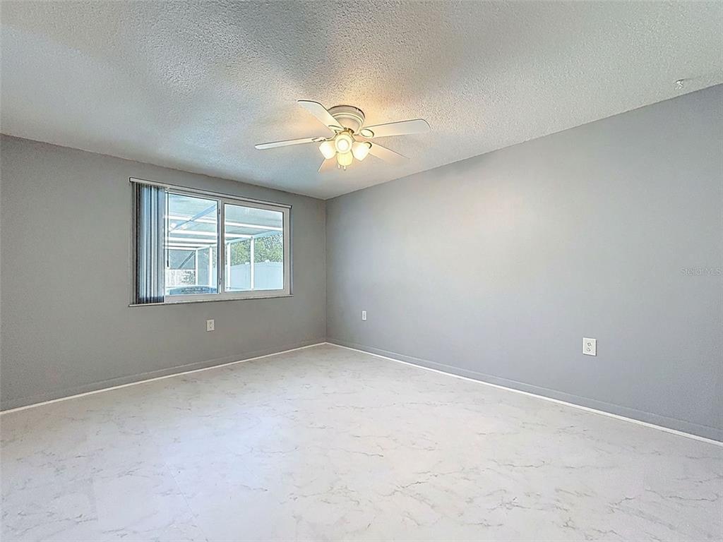 9610 Rainbow Lane Port Richey, FL 34668 - Photo 28 of 34 a view of an empty room with a window