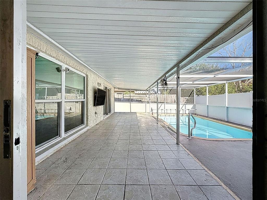 9610 Rainbow Lane Port Richey, FL 34668 - Photo 29 of 34 a view of empty room with wooden floor and fan