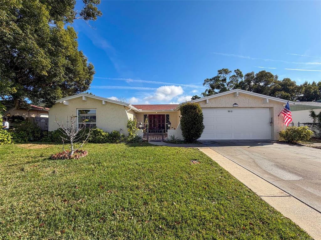 9610 Rainbow Lane Port Richey, FL 34668 - Photo 5 of 34 a front view of a house with a yard
