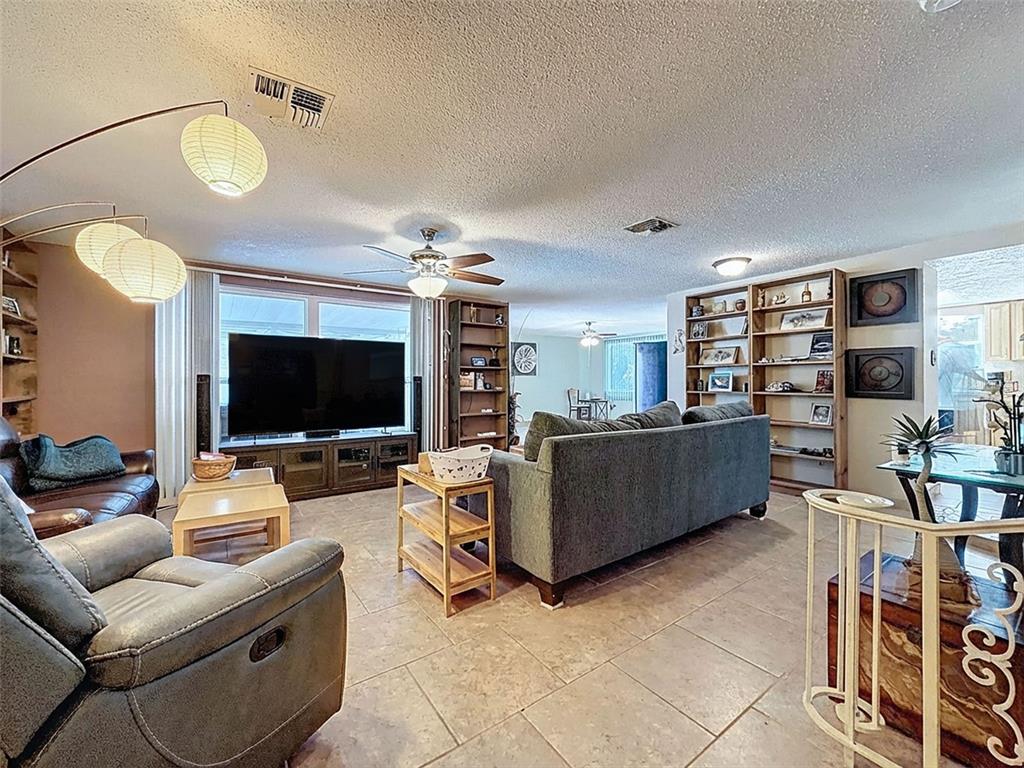 9610 Rainbow Lane Port Richey, FL 34668 - Photo 8 of 34 a living room with furniture and a flat screen tv