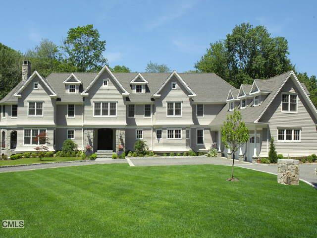 314 Den Road Stamford, CT 06903 - Photo 1 of 1 a front view of a house with a garden and trees