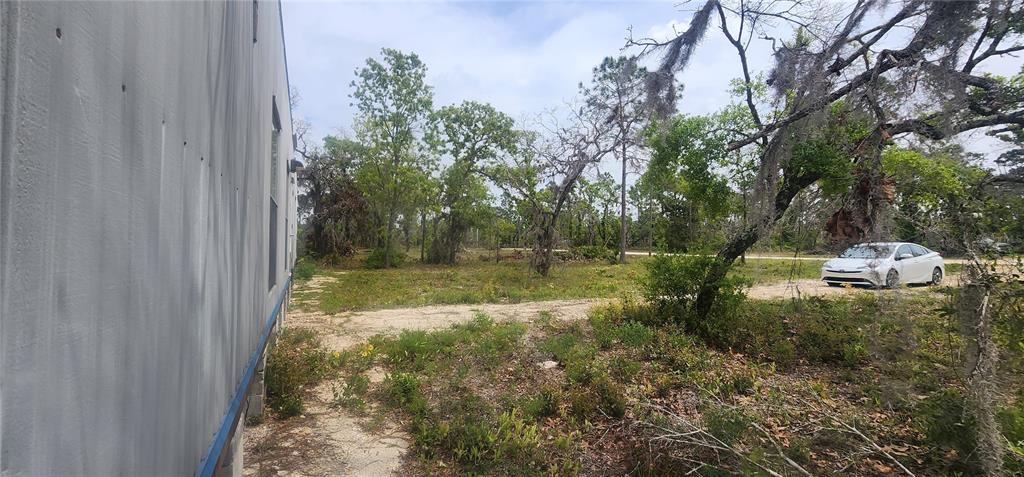 2228 Turkey Oak Road Perry, FL 32348 - Photo 32 of 76 a backyard of a house with a yard and outdoor seating