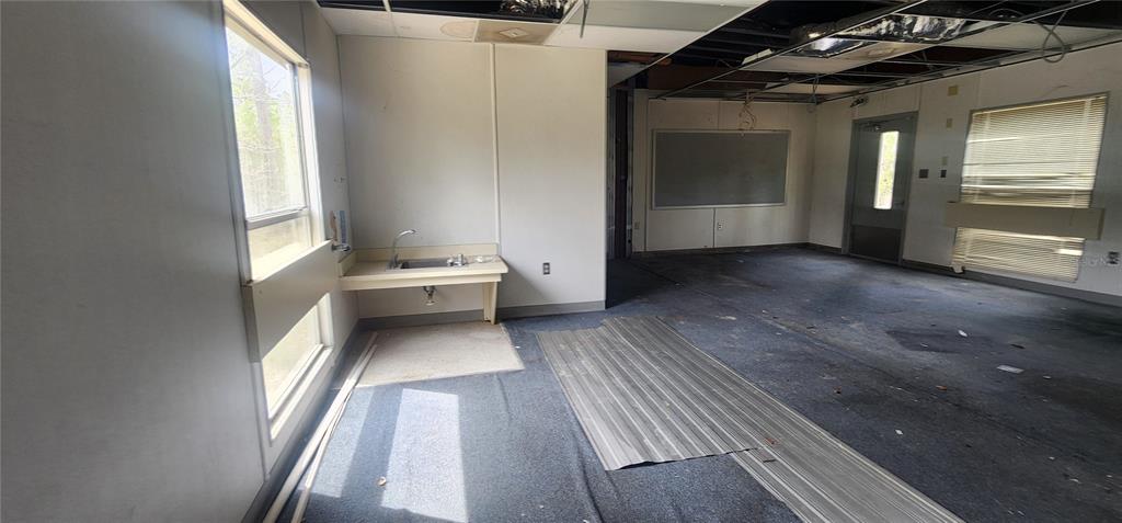 2228 Turkey Oak Road Perry, FL 32348 - Photo 38 of 76 a view of a hallway with wooden floor and furniture