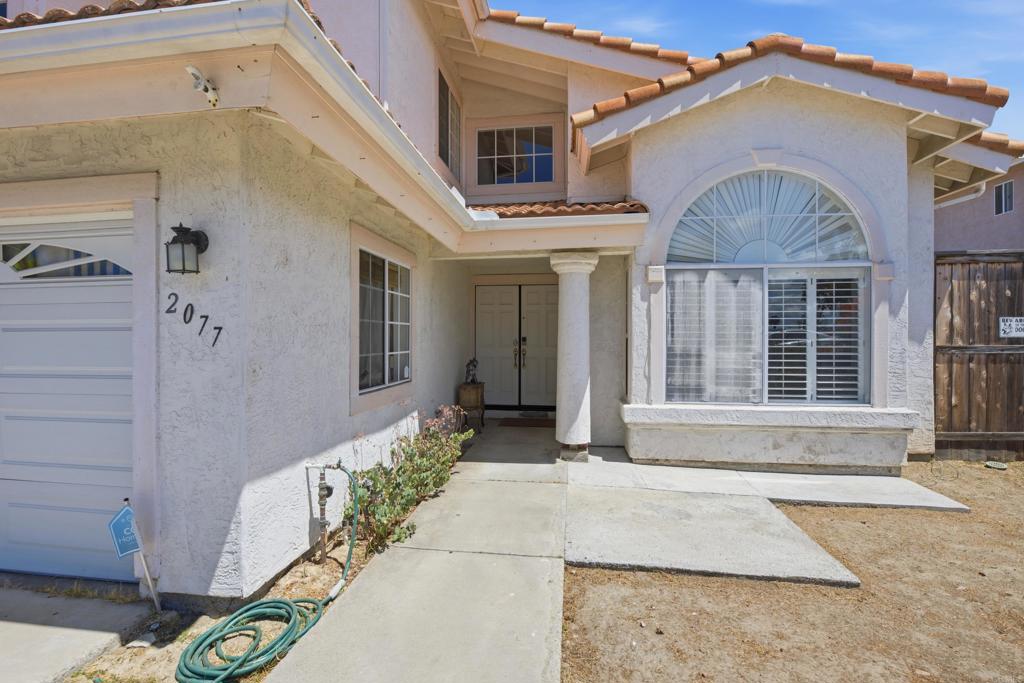 2077 Westwood Road Vista, CA 92083 - Photo 4 of 37 a front view of a house with a yard