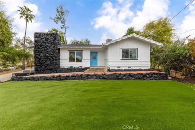 a front view of house with yard and green space