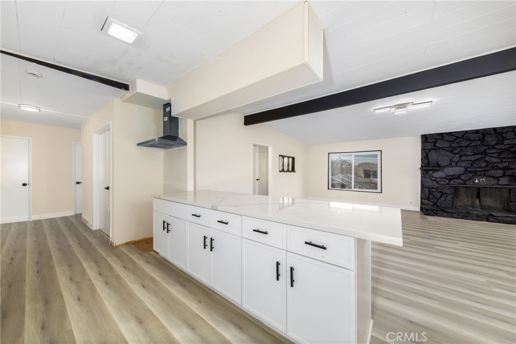 12449 6th Street Yucaipa, CA 92399 - Photo 11 of 37 a kitchen with cabinets and wooden floor