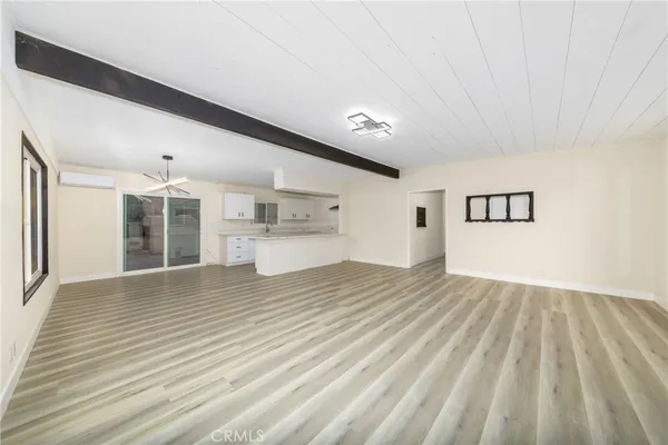 a large kitchen with granite countertop a large white cabinets and a dishwasher