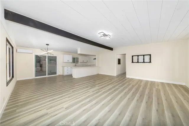 a large kitchen with granite countertop a large white cabinets and a dishwasher