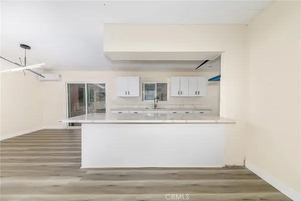 a kitchen with cabinets a sink and wooden floor
