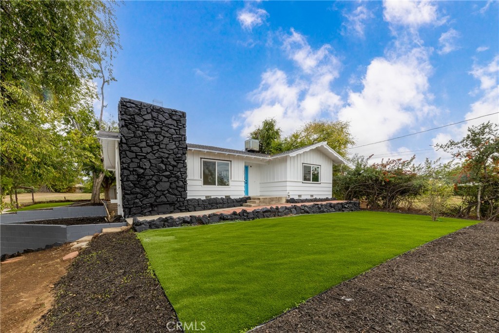 12449 6th Street Yucaipa, CA 92399 - Photo 2 of 37 a front view of a house with a yard