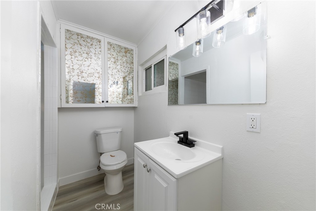 12449 6th Street Yucaipa, CA 92399 - Photo 21 of 37 a bathroom with a toilet sink and mirror