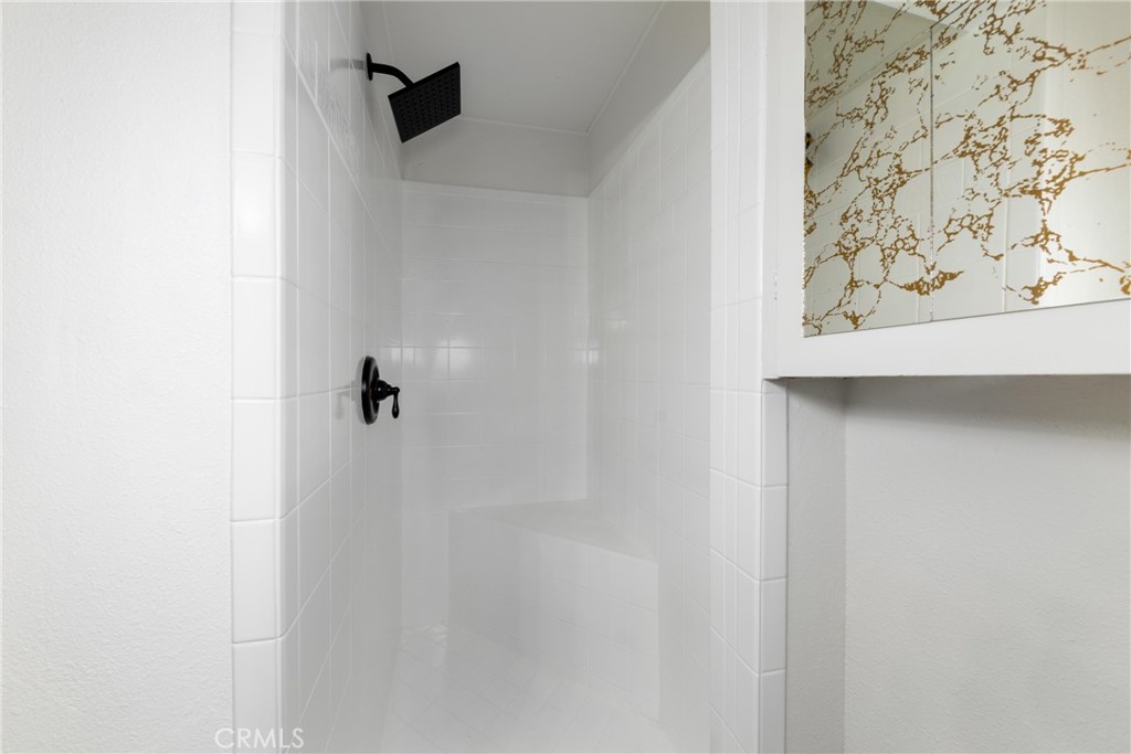 12449 6th Street Yucaipa, CA 92399 - Photo 22 of 37 a bathroom with a shower and a sink