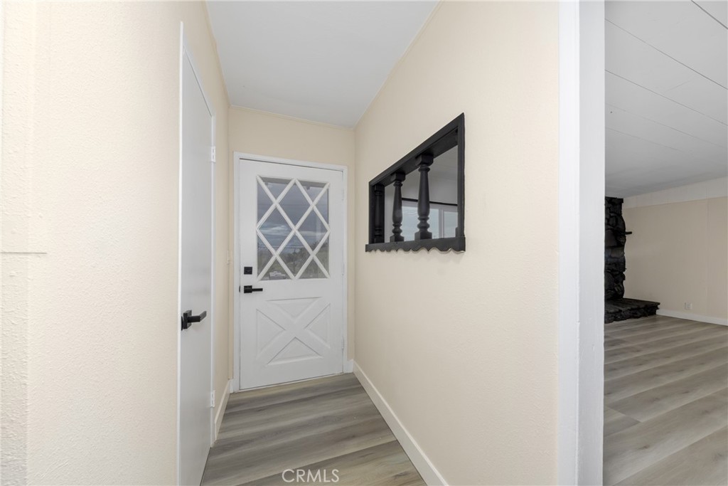 12449 6th Street Yucaipa, CA 92399 - Photo 23 of 37 a view of a hallway with wooden floor and closet