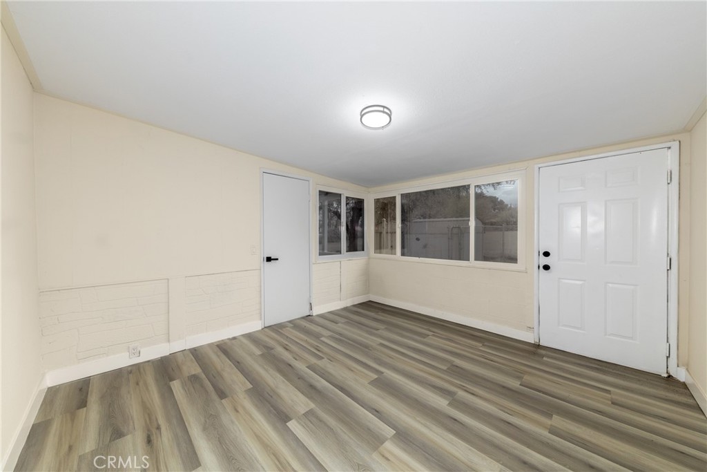 12449 6th Street Yucaipa, CA 92399 - Photo 27 of 37 an empty room with wooden floor and windows