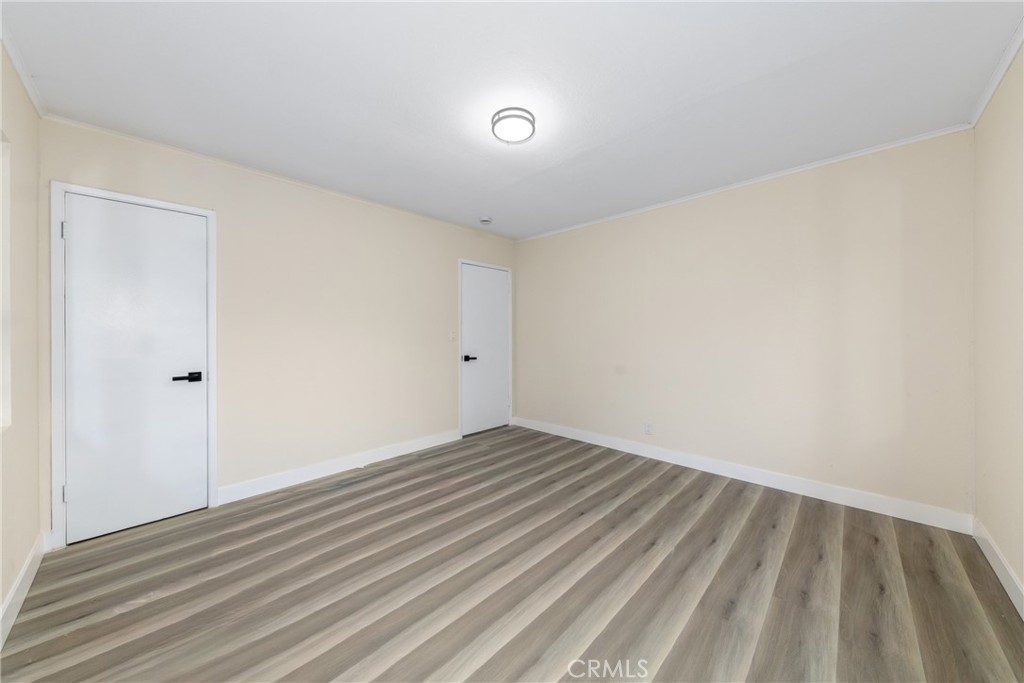 12449 6th Street Yucaipa, CA 92399 - Photo 30 of 37 a view of an empty room with wooden floor