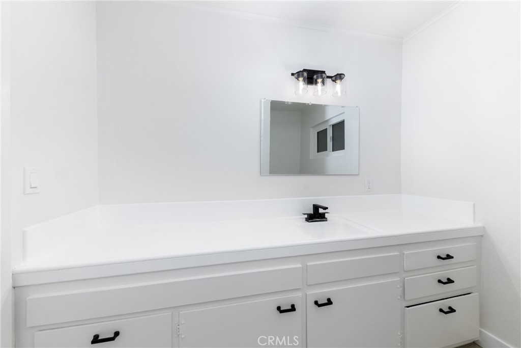 12449 6th Street Yucaipa, CA 92399 - Photo 31 of 37 a bathroom with a sink and a mirror