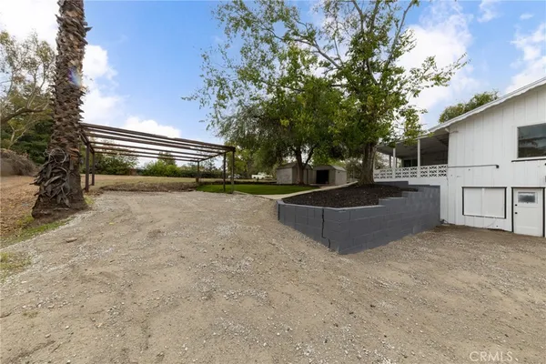 a front view of a house with a yard and trees