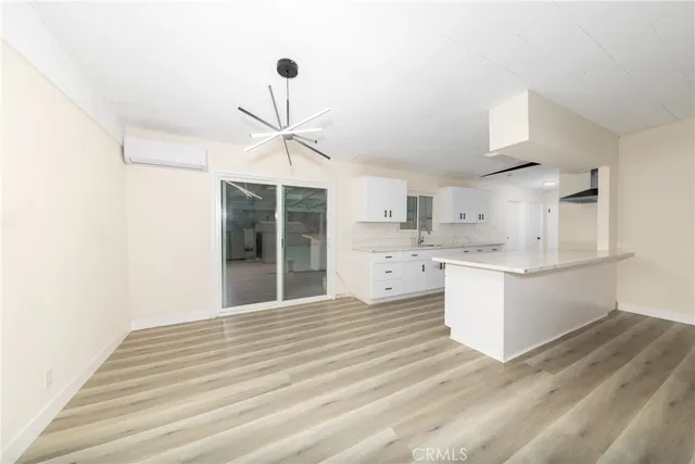 a kitchen with cabinets and wooden floor