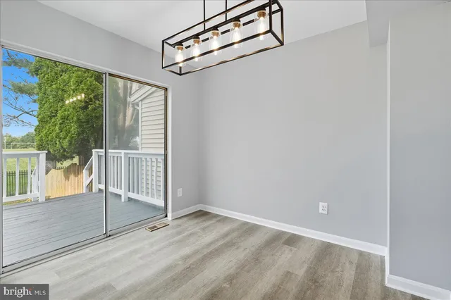 a view of a room with wooden floor and windows
