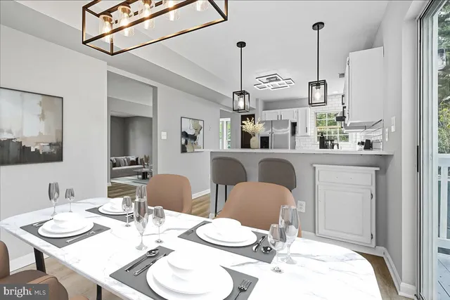 a dining room with furniture and a chandelier