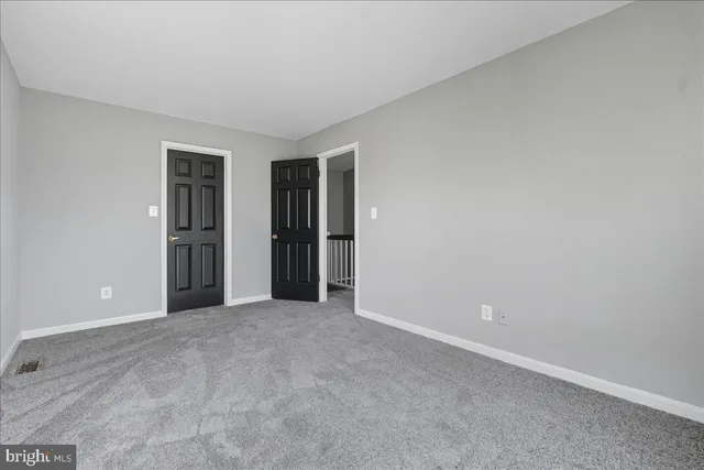an empty room with closet and a window