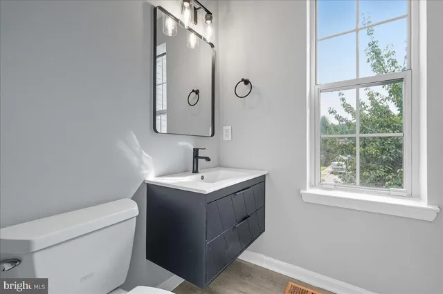 a bathroom with a toilet sink and mirror