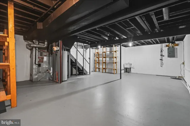 a view of water heater room with stairs