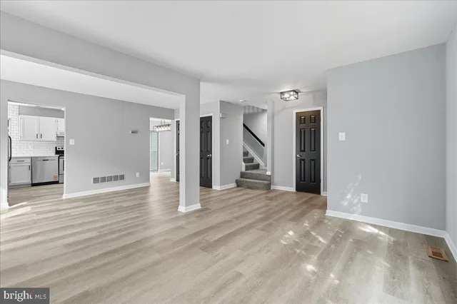 a view of a big room with closet and windows