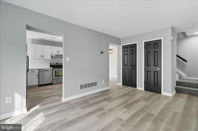 a view of a kitchen with a sink and a refrigerator