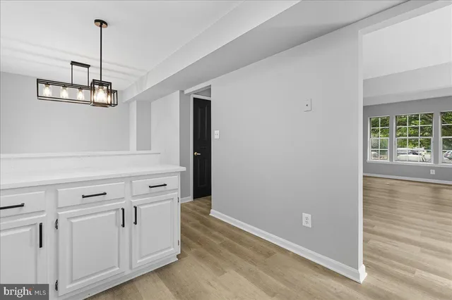 a view of a hallway with chandelier