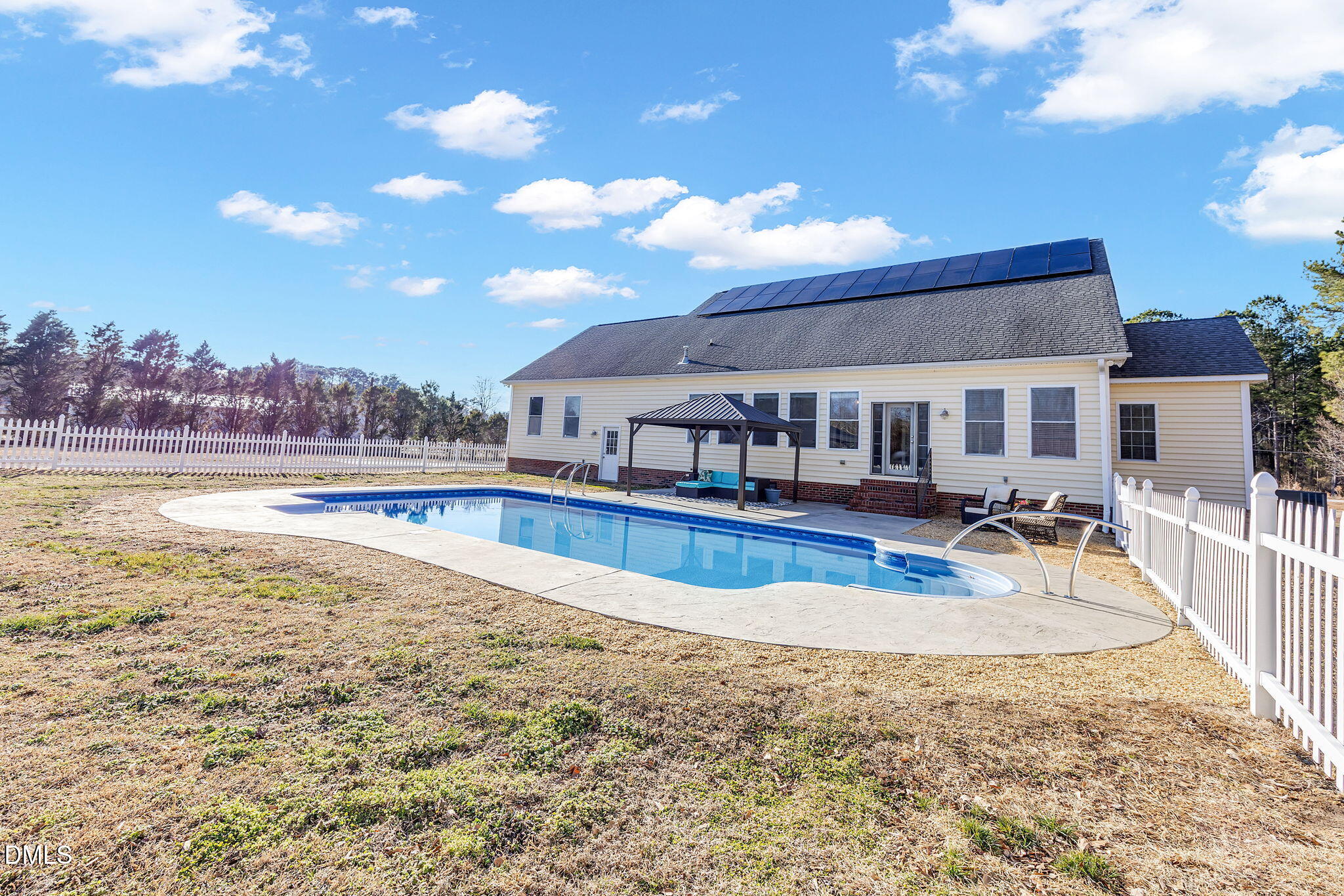 1869 Firetower Road Selma, NC 27576 - Photo 10 of 67 a view of a swimming pool with an outdoor seating and a yard