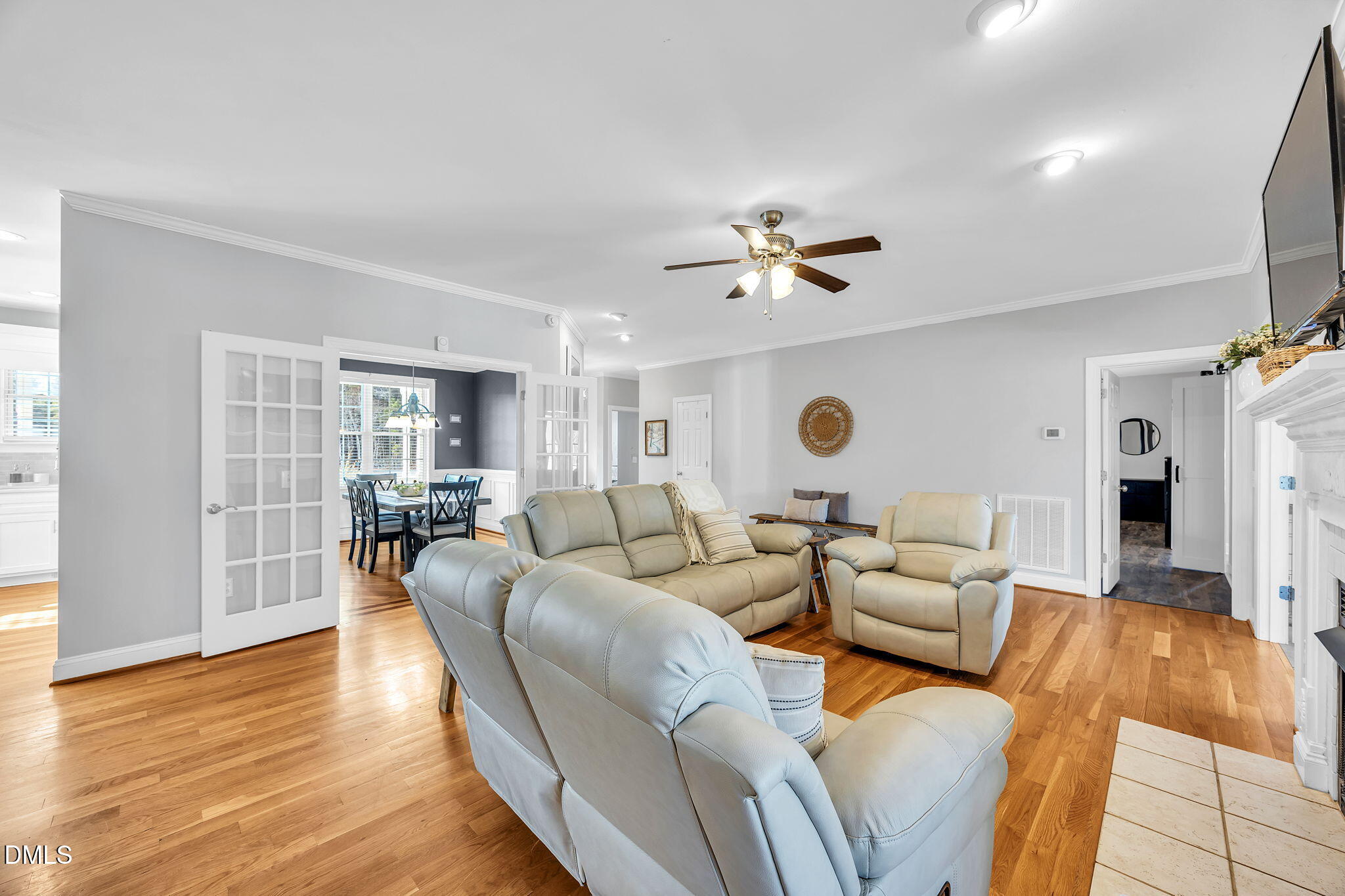 1869 Firetower Road Selma, NC 27576 - Photo 18 of 67 a living room with furniture and a chandelier
