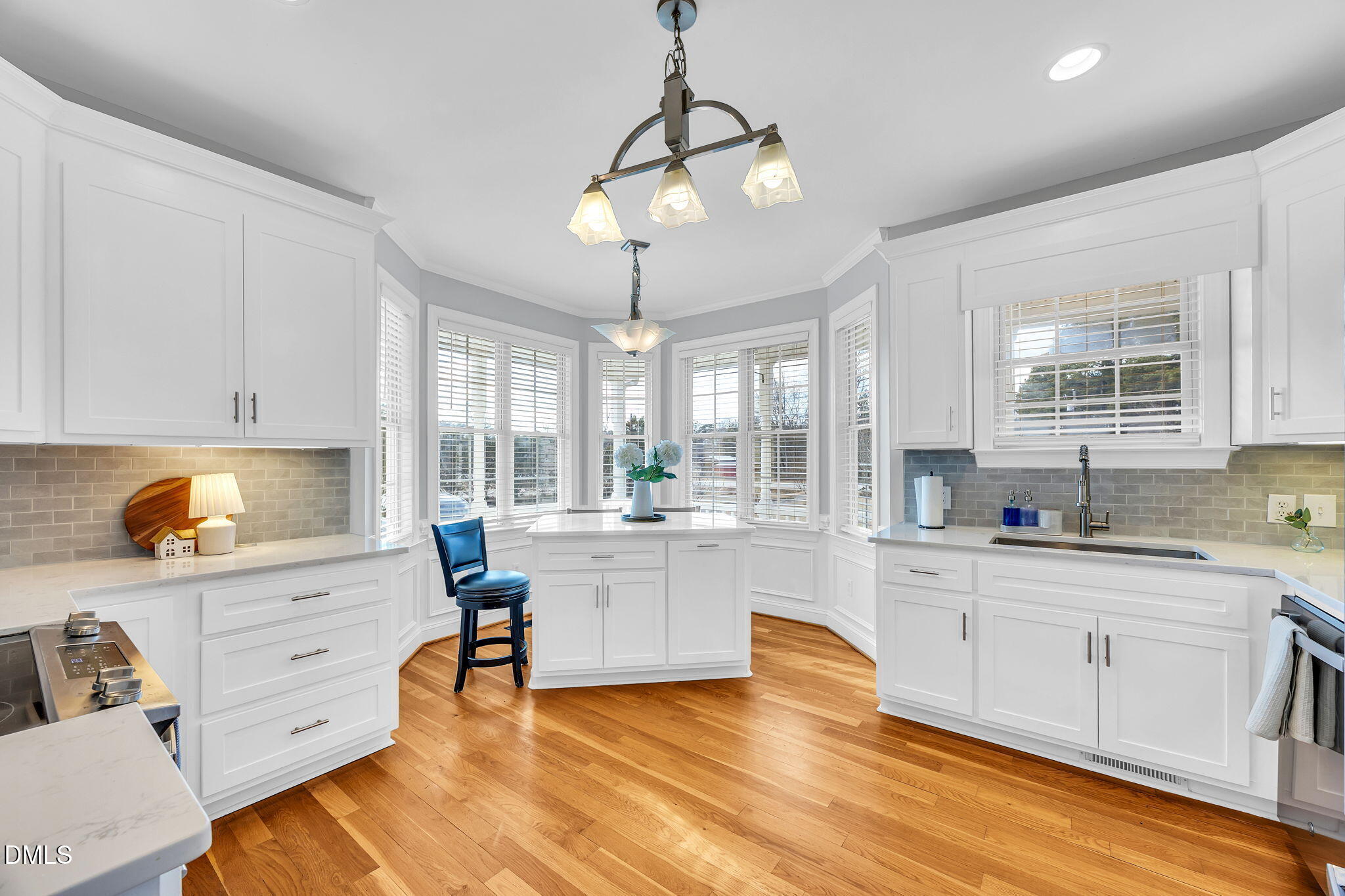 1869 Firetower Road Selma, NC 27576 - Photo 24 of 67 a large white kitchen with cabinets and wooden floor
