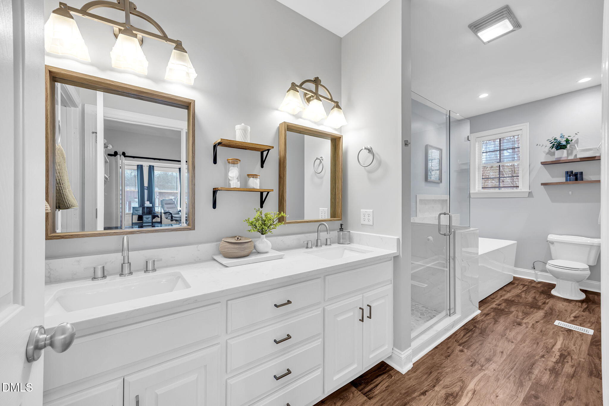 1869 Firetower Road Selma, NC 27576 - Photo 43 of 67 a spacious bathroom with double sink a toilet a mirror and shower