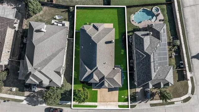an aerial view of a house with a backyard space and sitting space