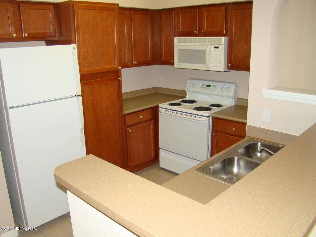 8550 Touchton Road, Unit 323 Jacksonville, FL 32216 - Photo 4 of 19 a utility room with dryer and washer