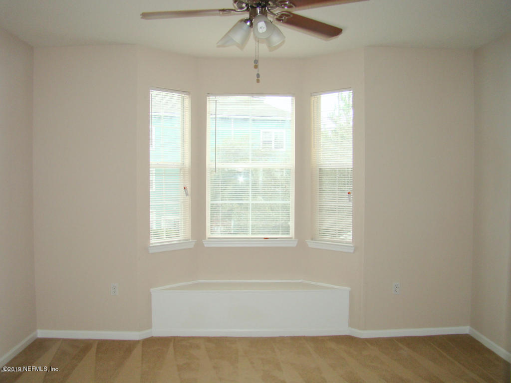 8550 Touchton Road, Unit 323 Jacksonville, FL 32216 - Photo 8 of 19 a bathroom with a window and a chandelier