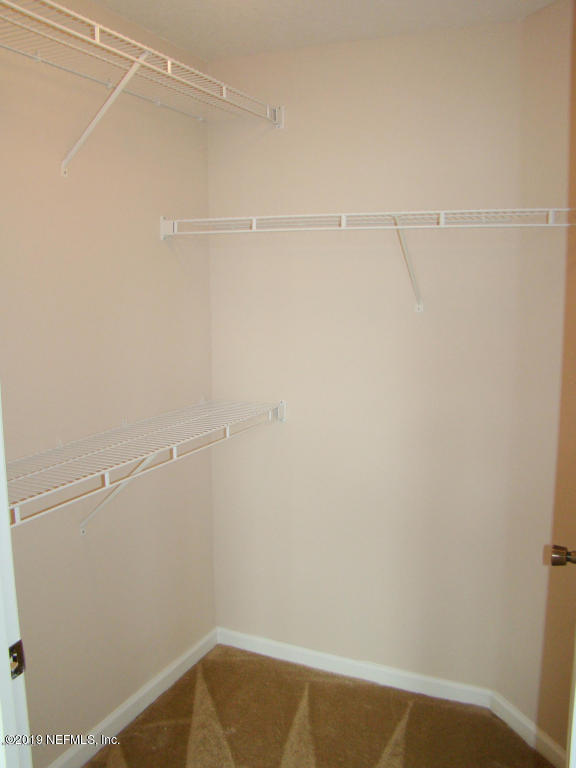 8550 Touchton Road, Unit 323 Jacksonville, FL 32216 - Photo 9 of 19 a view of a room with racks on the wall