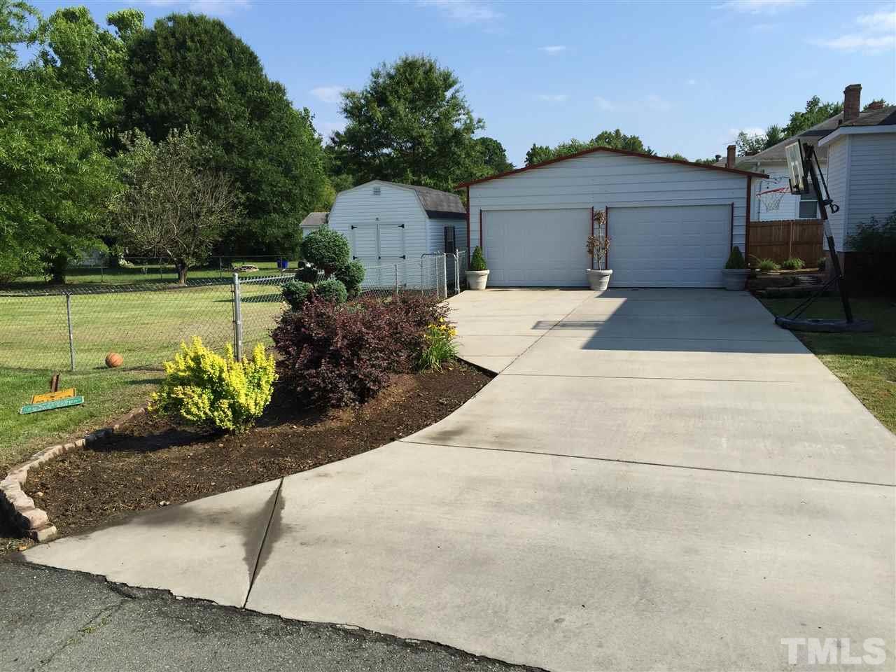 1953 Old Durham Road Roxboro, NC 27573 - Photo 2 of 10 a front view of a house with a garden