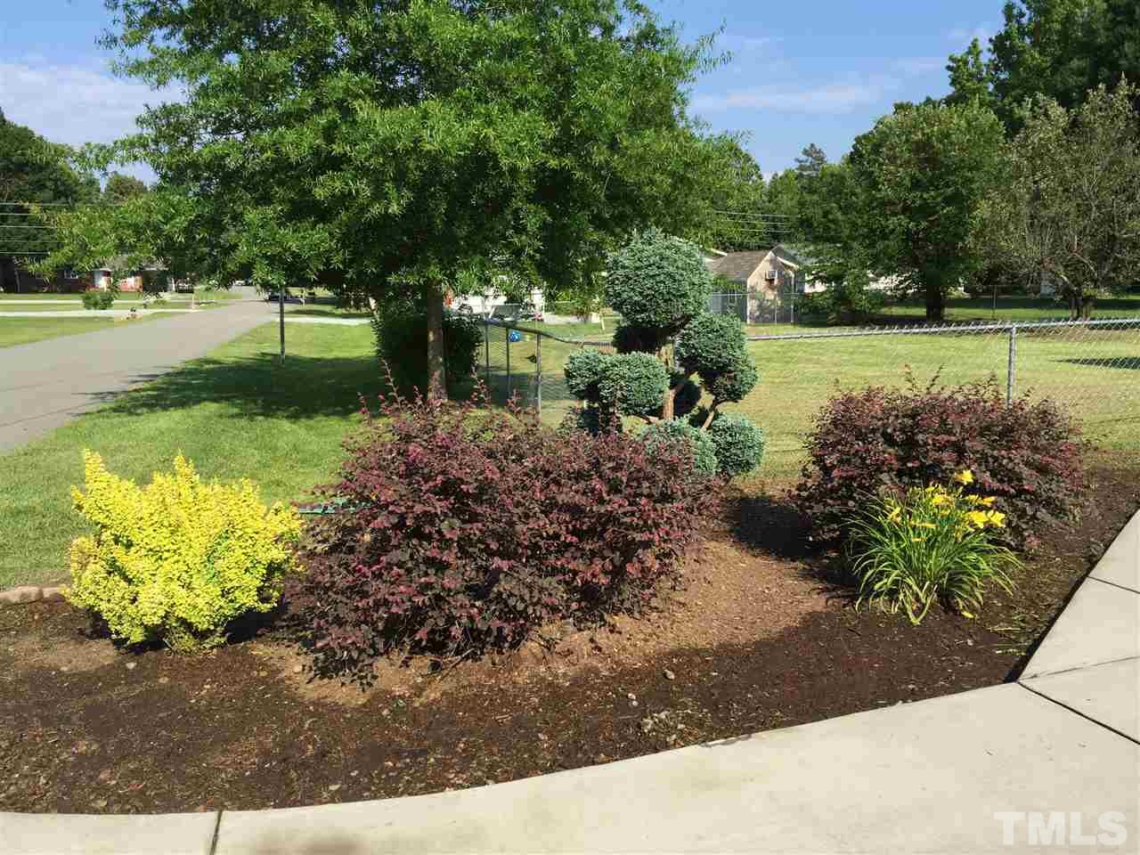 1953 Old Durham Road Roxboro, NC 27573 - Photo 8 of 10 a view of a garden with large trees