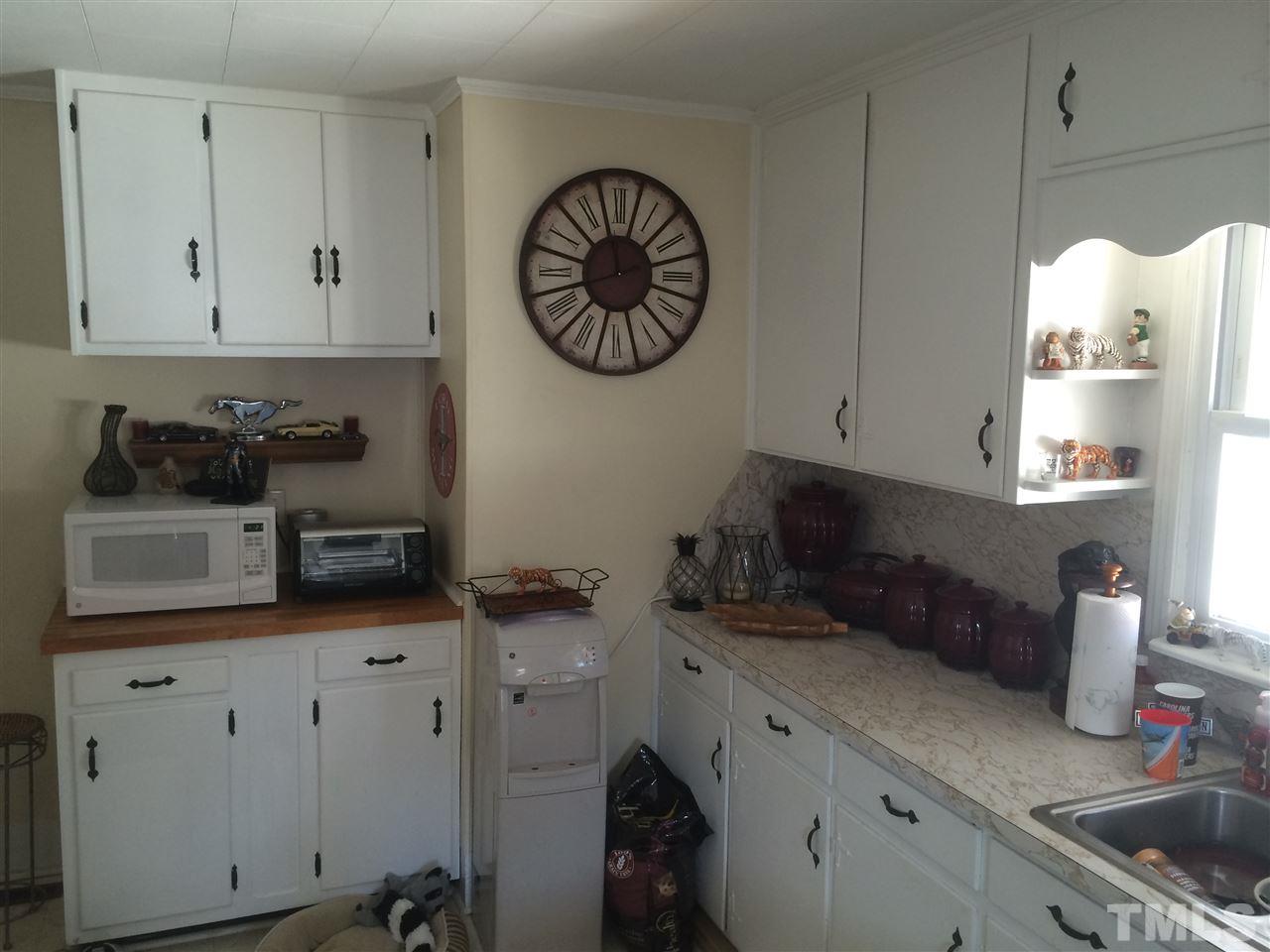 1953 Old Durham Road Roxboro, NC 27573 - Photo 9 of 10 a kitchen with white cabinets and a stove
