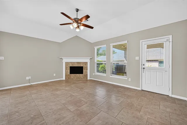 a living room with a fireplace and windows