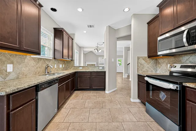 a kitchen with a sink stainless steel appliances and cabinets