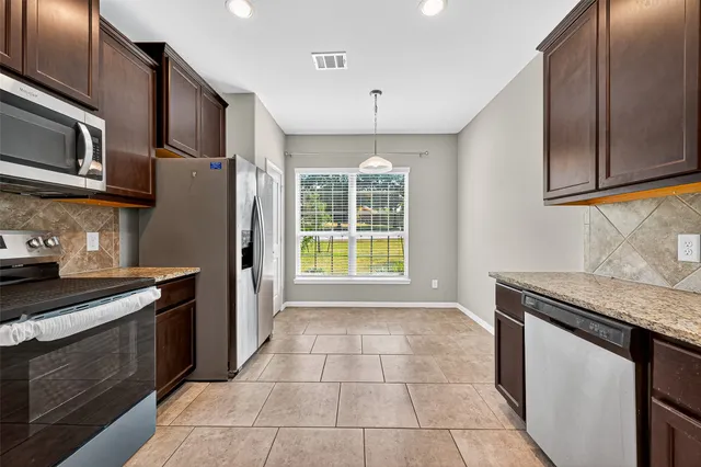 a kitchen with a stove microwave and refrigerator