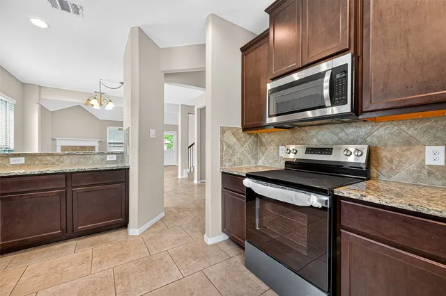 a kitchen with granite countertop sink and cabinets