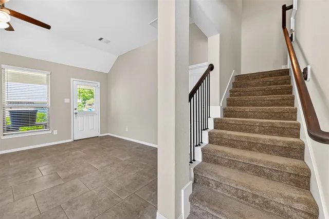 an empty room with a chandelier fan