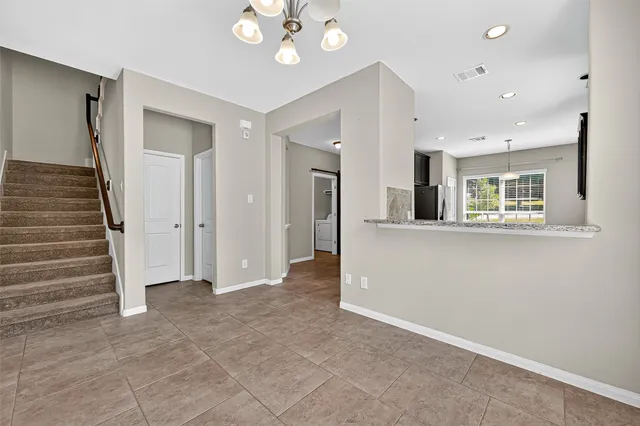 a view of an empty room with a fireplace and a window