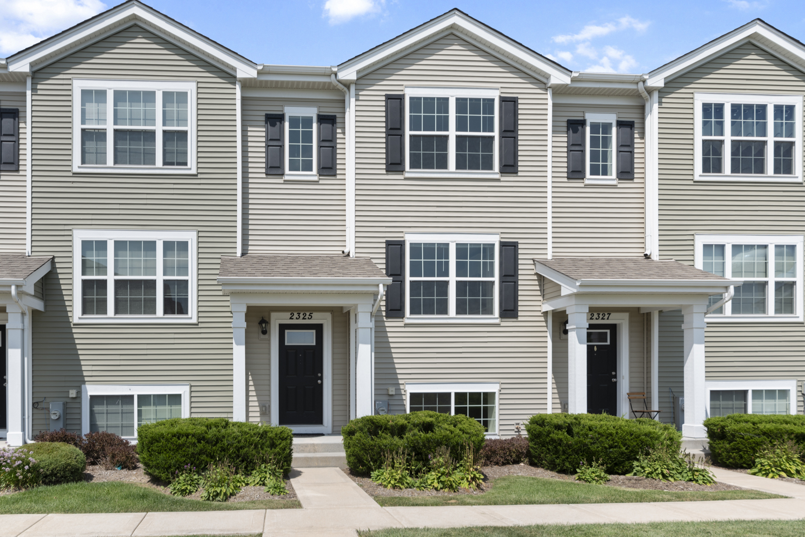 a front view of a house with a yard