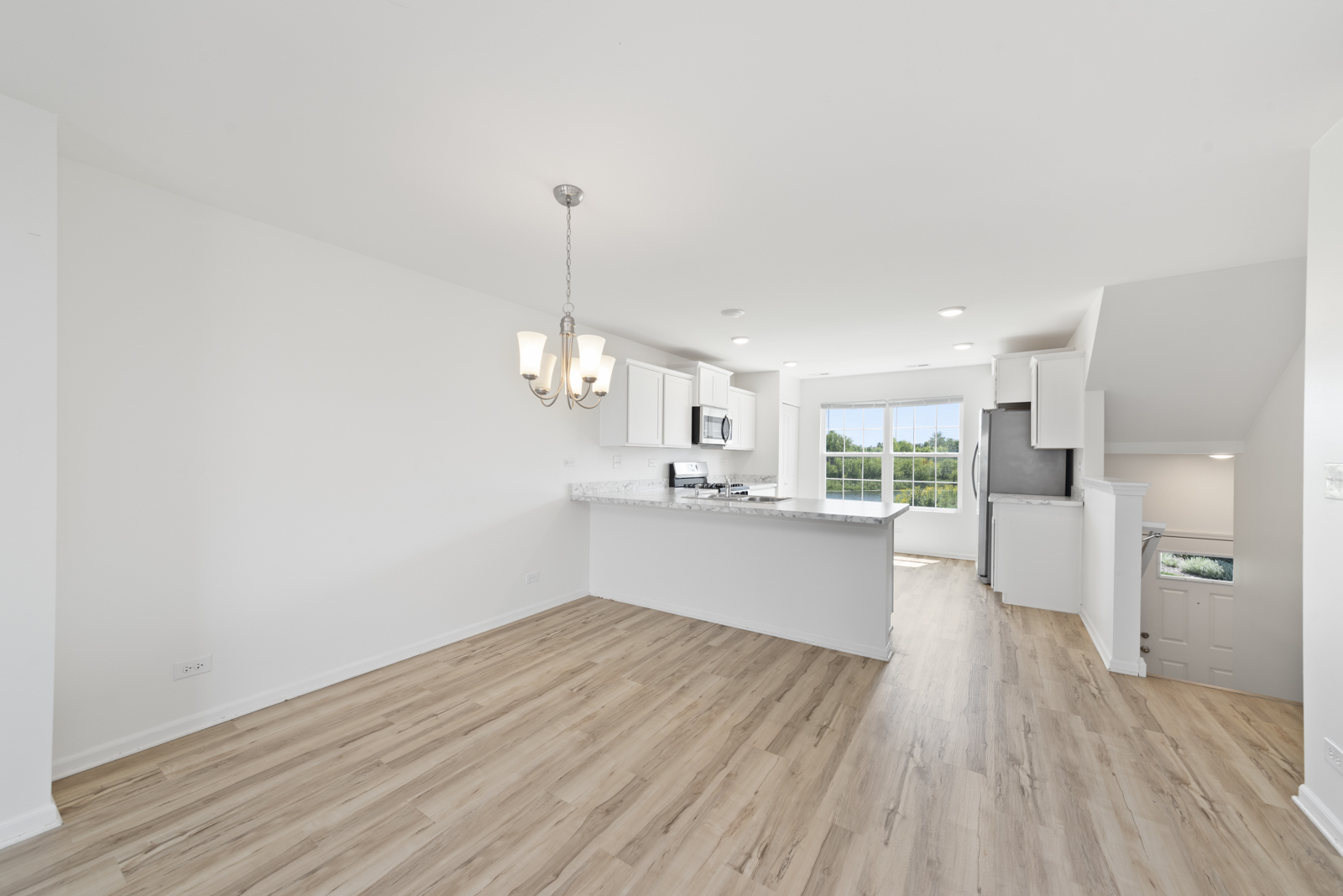 2325 Upland Road Pingree Grove, IL 60140 - Photo 5 of 18 a view of a kitchen with wooden floor